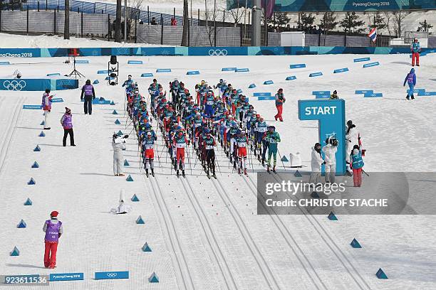 Athletes line up at the start line in the men's 50km cross country mass start classic at the Alpensia cross country ski centre during the Pyeongchang...