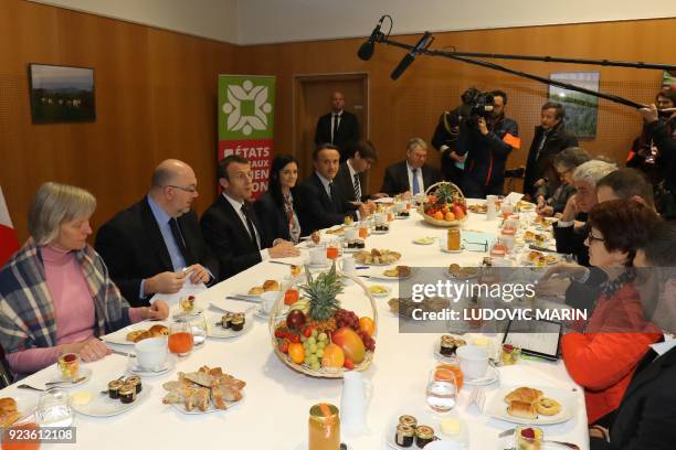 French President Emmanuel Macron attends a breakfast with agricultural unions and chambers, flanked by French Agriculture Minister Stéphane Travert...