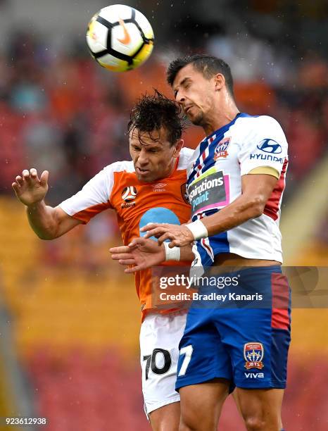 Brett Holman of the Roar and Daniel Georgievski of the Jets challenge for the ball during the round 21 A-League match between the Brisbane Roar and...