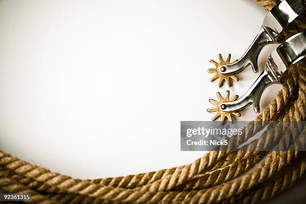 a white background bordered in ropes and spurs - rodeo background stock pictures, royalty-free photos & images