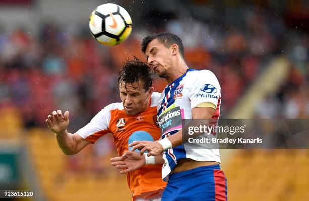 Brett Holman of the Roar and Daniel Georgievski of the Jets challenge for the ball during the round 21 A-League match between the Brisbane Roar and...