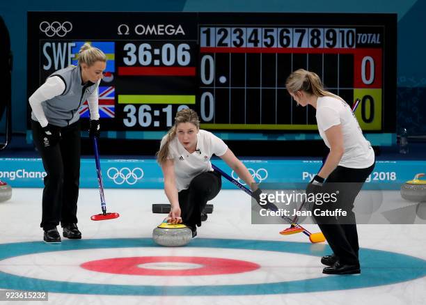 Lauren Gray of Great Britain throws a stone surrounded by Anna Sloan and Vicki Adams during the women's curling semifinal game between Sweden and...