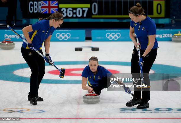 Sofia Mabergs of Sweden throws a stone surrounded by teammates Sara McManus and Agnes Knochenhauer during the women's curling semifinal game between...