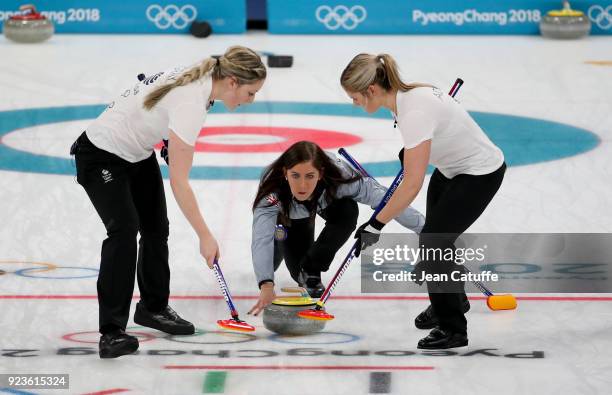 Skipper Eve Muirhead of Great Britain throws a stone surrounded by teammates Lauren Gray and Vicki Adams during the women's curling semifinal game...