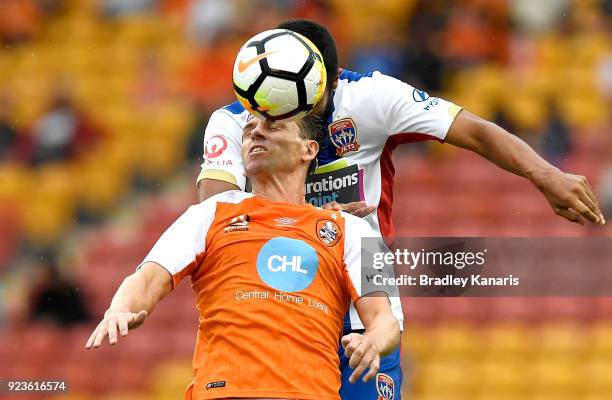 Brett Holman of the Roar and Nikolai Topor-Stanley of the Jets challenge for the ball during the round 21 A-League match between the Brisbane Roar...