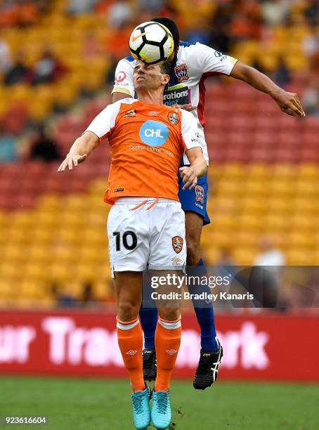 Brett Holman of the Roar and Nikolai Topor-Stanley of the Jets challenge for the ball during the round 21 A-League match between the Brisbane Roar...