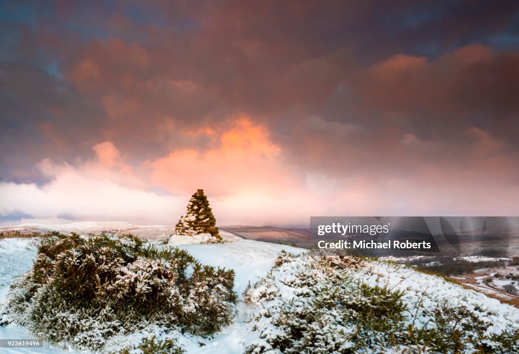 Cairn on snow covered hill fort at Cwmyoy near Abergavenny in the Black Mountains, Brecon Beacons national park, Wales.
