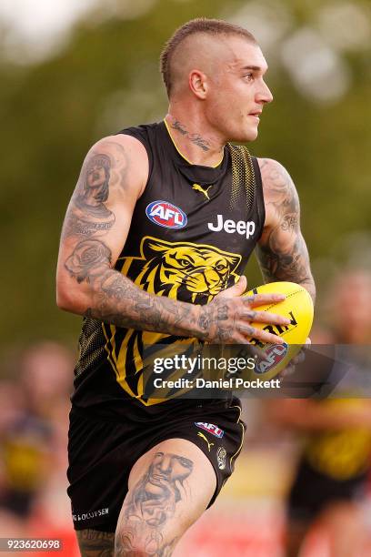 Dustin Martin of the Tigers runs with the ball during the JLT Community Series AFL match between the Essendon Bombers and the Richmond Tigers at Norm...