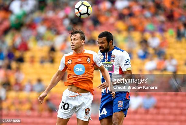 Bret Holman of the Roar and Nikolai Topor-Stanley of the Jets compete for the ball during the round 21 A-League match between the Brisbane Roar and...