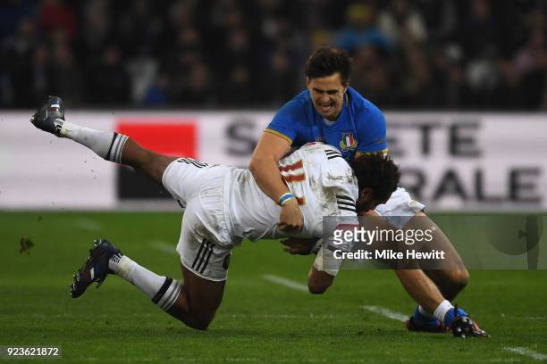 Benjamin Fall of France is tackled by Tommaso Benvenuti of Italy during the NatWest Six Nations match between France and Italy at Stade Velodrome on...
