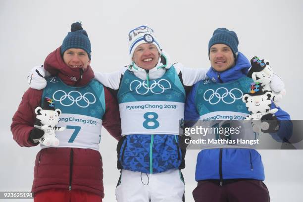 Silver medalist Alexander Bolshunov of Olympic Athlete from Russia, gold medalist Iivo Niskanen of Finland and bronze medalist Andrey Larkov of...