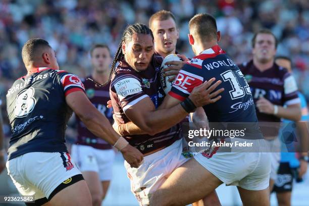 Martin Taupau of the Sea Eagles is tackled by the Roosters defence during the NRL Trial match between the Manly Sea Eagles and the Sydney Roosters at...