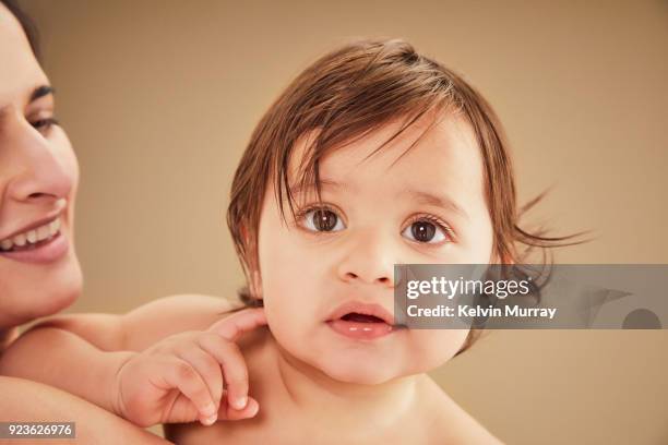mother holding baby boy (11-12 months) - 12 17 mois photos et images de collection
