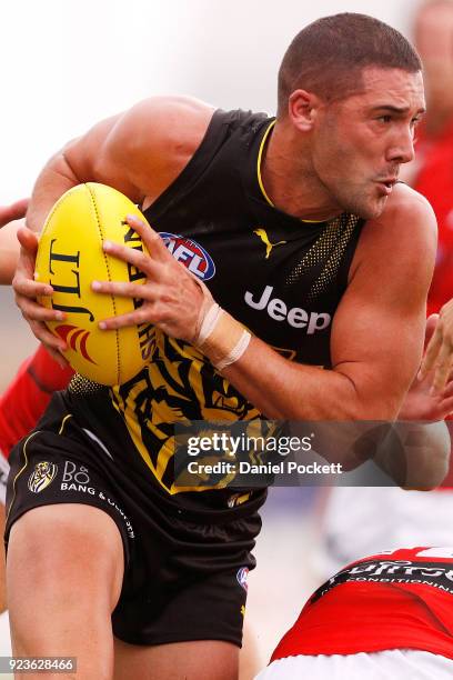 Shaun Grigg of the Tigers runs with the ball during the JLT Community Series AFL match between the Essendon Bombers and the Richmond Tigers at Norm...