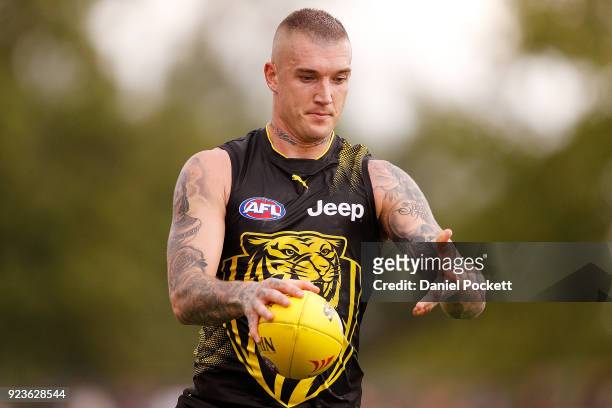 Dustin Martin of the Tigers runs with the ball during the JLT Community Series AFL match between the Essendon Bombers and the Richmond Tigers at Norm...