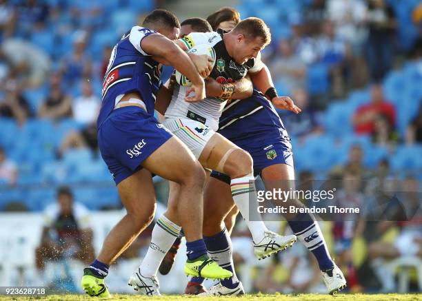 Trent Merrin of the Panthers is tackled by the Bulldogs defence during the NRL trial match between the Penrith Panthers ands the Canterbury Bulldogs...