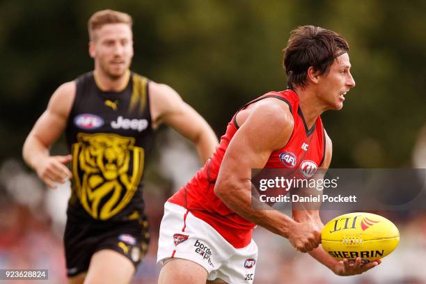 Mark Baguley of the Bombers handpasses the ball during the JLT Community Series AFL match between the Essendon Bombers and the Richmond Tigers at...