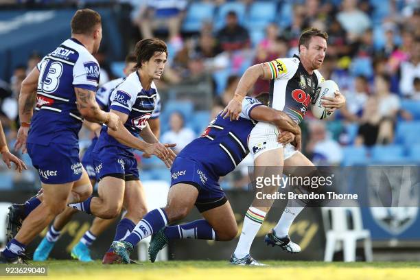 James Maloney of the Panthers is tackled by the Bulldogs defence during the NRL trial match between the Penrith Panthers ands the Canterbury Bulldogs...