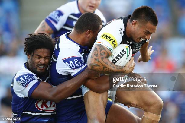 Dean Whare of the Panthers is tackled by the Bulldogs defence during the NRL trial match between the Penrith Panthers ands the Canterbury Bulldogs at...