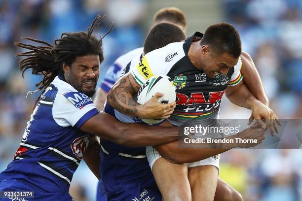 Dean Whare of the Panthers is tackled by the Bulldogs defence during the NRL trial match between the Penrith Panthers ands the Canterbury Bulldogs at...