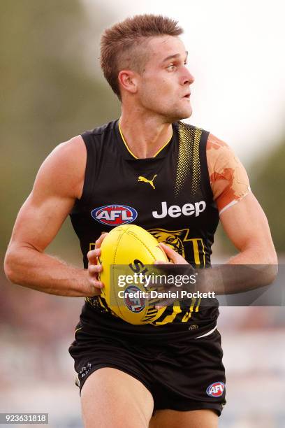 Jayden Short of the Tigers runs with the ball during the JLT Community Series AFL match between the Essendon Bombers and the Richmond Tigers at Norm...