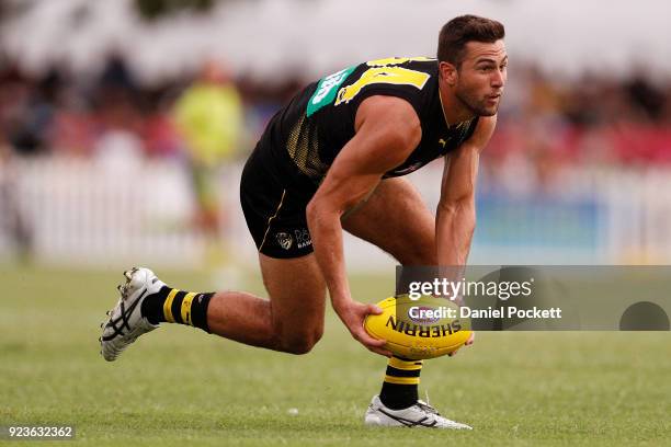 Jack Graham of the Tigers runs with the ball during the JLT Community Series AFL match between the Essendon Bombers and the Richmond Tigers at Norm...