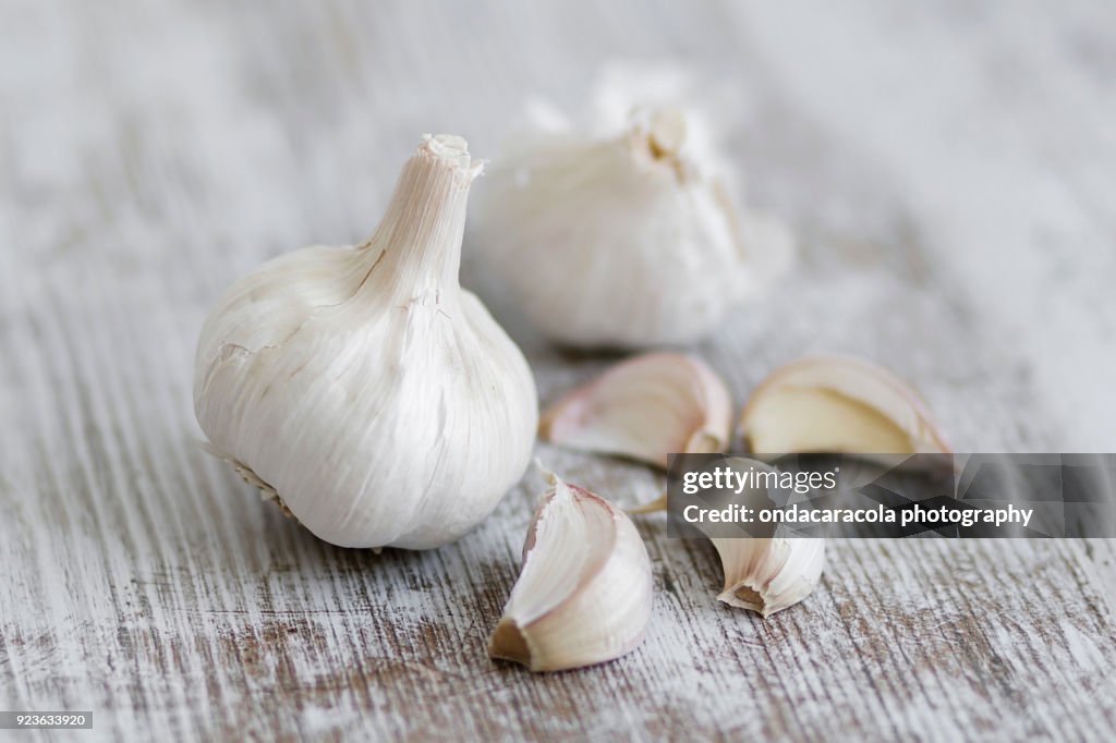 Garlic cloves over a rustic background