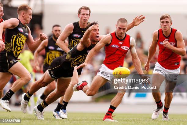 David Zaharakis of the Bombers kicks the ball under pressure from Alex Rance of the Tigers during the JLT Community Series AFL match between the...