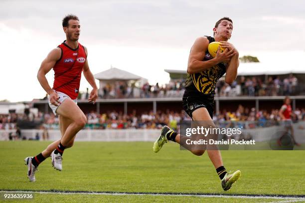 Jason Castagna of the Tigers marks the ball during the JLT Community Series AFL match between the Essendon Bombers and the Richmond Tigers at Norm...