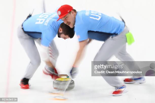 Matt Hamilton and John Landsteiner of the United States deliver a stone against Sweden during the Curling Men's Gold Medal game on day fifteen of the...