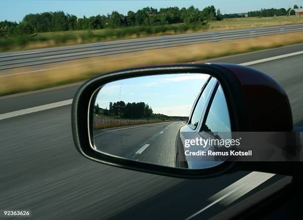 rear view reflected in a car mirror - vehicle mirror stock pictures, royalty-free photos & images