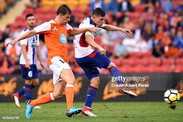 Wayne Brown of the Jets shoots on goal under pressure from Brett Holman of the Roar during the round 21 A-League match between the Brisbane Roar and...