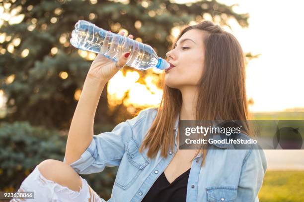 woman drinking water - drinking from bottle stock pictures, royalty-free photos & images