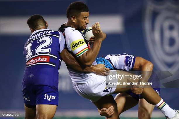 Viliame Kikau of the Panthers is tackled by the Bulldogs defence during the NRL trial match between the Penrith Panthers ands the Canterbury Bulldogs...