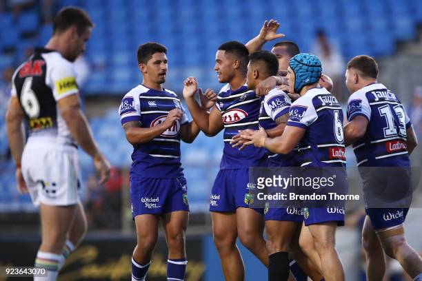 Fa'amanu Brown of the Bulldogs celebrates with team mates after scoring a try during the NRL trial match between the Penrith Panthers ands the...