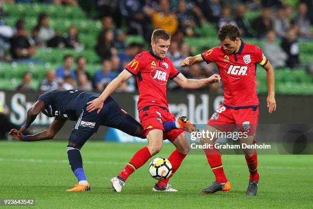 Ryan Kitto of United is tackled during the round 21 A-League match between the Melbourne Victory and Adelaide United at AAMI Park on February 24,...