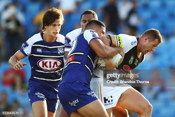 Trent Merrin of the Panthers is tackled by the Bulldogs defence during the NRL trial match between the Penrith Panthers ands the Canterbury Bulldogs...