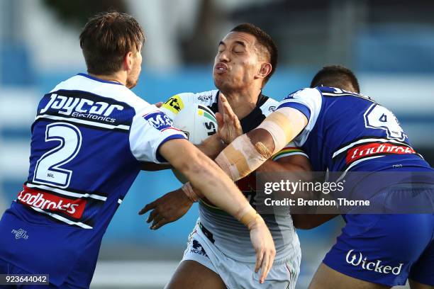 Dean Whare of the Panthers is tackled by the Bulldogs defence during the NRL trial match between the Penrith Panthers ands the Canterbury Bulldogs at...