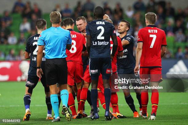 United and Victory players have a disagreement during the round 21 A-League match between the Melbourne Victory and Adelaide United at AAMI Park on...