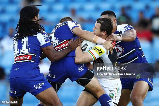 Dylan Edwards of the Panthers is tackled by the Bulldogs defence during the NRL trial match between the Penrith Panthers ands the Canterbury Bulldogs...