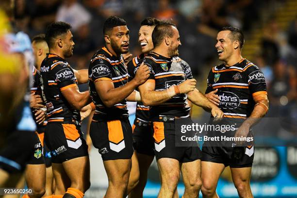 Corey Thompson of the Tigers celebrates with Josh Reynolds of the Tigers after scoring a try during the NRL trial match between the Cronulla Sharks...