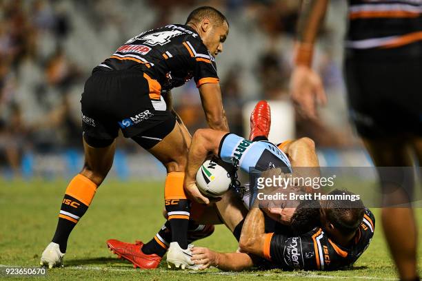 Chad Townsend of the Sharks is tackled by Josh Reynolds of the Tigers during the NRL trial match between the Cronulla Sharks and the Wests Tigers at...