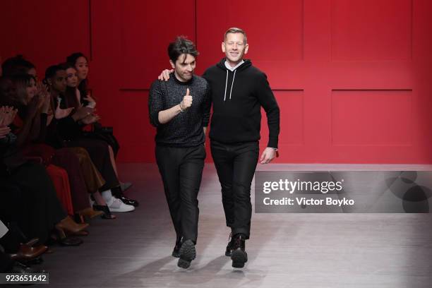 Designers Guillaume Meilland and Paul Andrew acknowledge the applause of the audience at the Salvatore Ferragamo show during Milan Fashion Week...