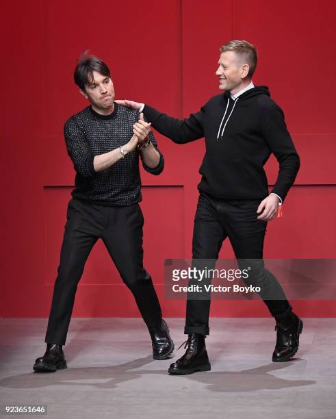 Designers Guillaume Meilland and Paul Andrew acknowledge the applause of the audience at the Salvatore Ferragamo show during Milan Fashion Week...