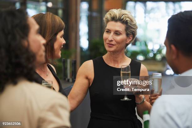 group of mature people in a bar. - elegant mature woman stock pictures, royalty-free photos & images
