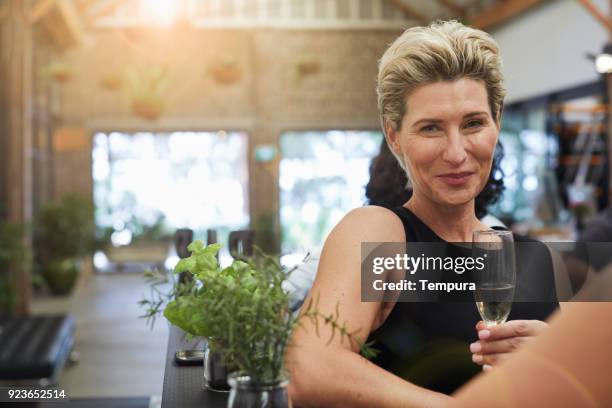 woman toasting with a glass of champagne. - elegance stock pictures, royalty-free photos & images