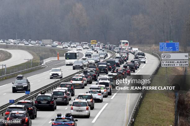 Vehicles stand in traffic jams on the A43 road between Chambery and Albertville, central eastern France on february 24 as vacationers cross each...