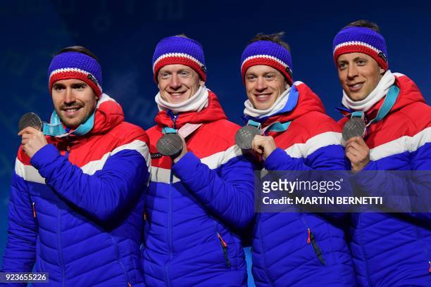 Norway's silver medallists Lars Helge Birkeland, Tarjei Boe, Johannes Thingnes Boe and Emil Hegle Svendsen pose on the podium during the medal...