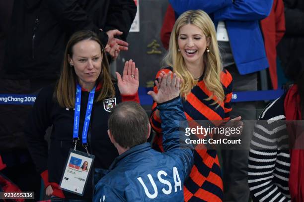 Ivanka Trump high fives a spectator after the United States of America beat Sweden in their Men's Gold Medal Curling match next to former Olympic US...