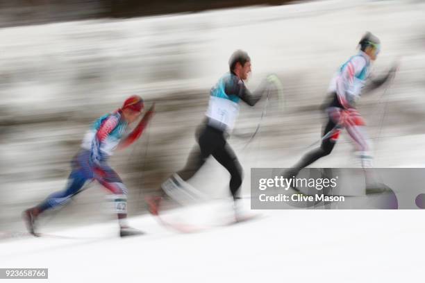 Noah Hoffman of the United States, Thomas Bing of Germany and Max Hauke of Austria compete during the Men's 50km Mass Start Classic on day 15 of the...